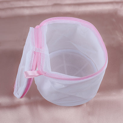 Sturdy polyester mesh laundry bag for delicates with fine grid, pink zipper. Hand washable, prevents deformation in washing machine. Breathable mesh design, laundry room essential.