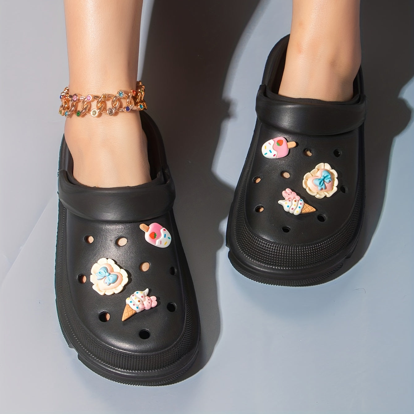 Women's cute cartoon clogs with round toe and breathable design for comfortable wear.