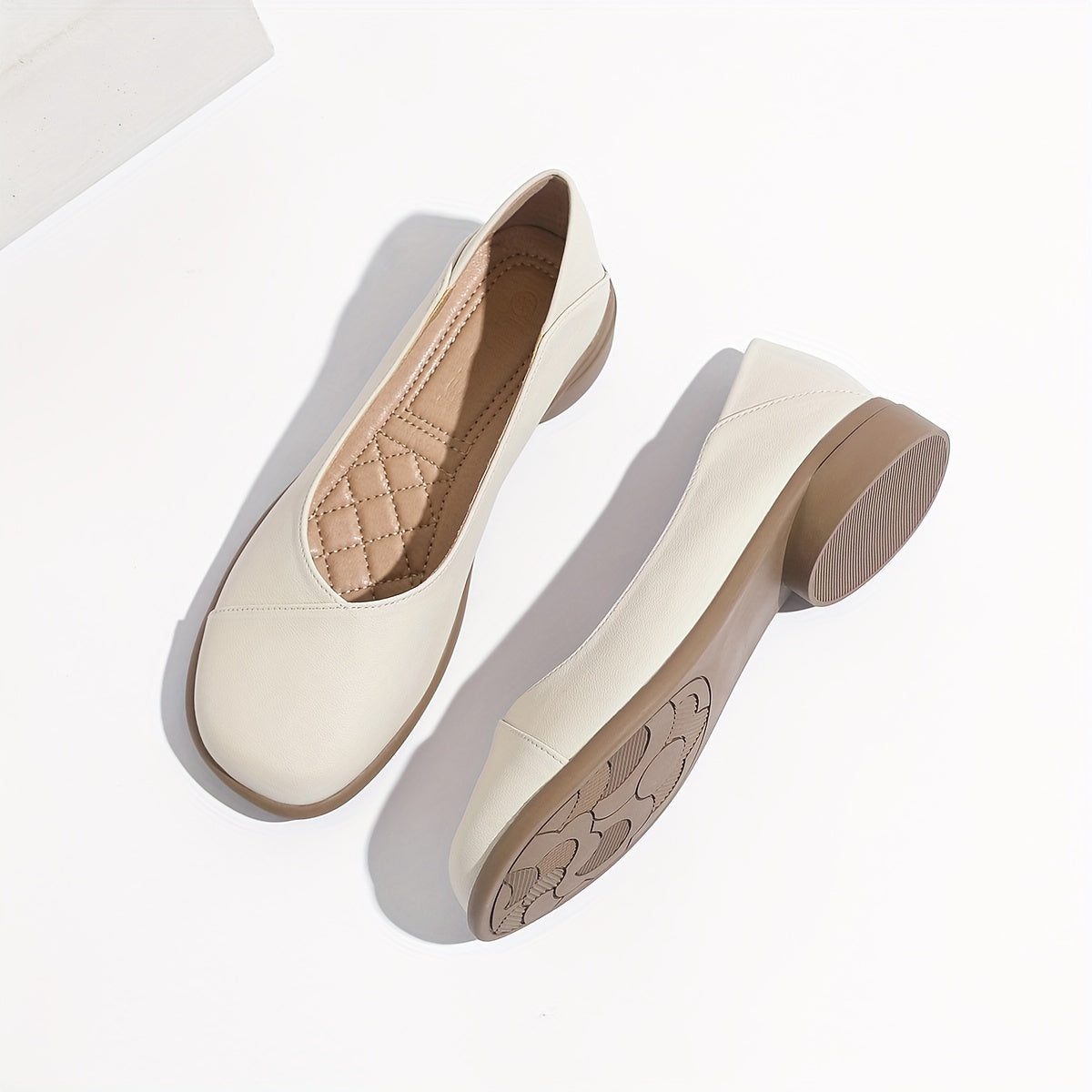 Stylish white low heel flats with all-day comfort for work.