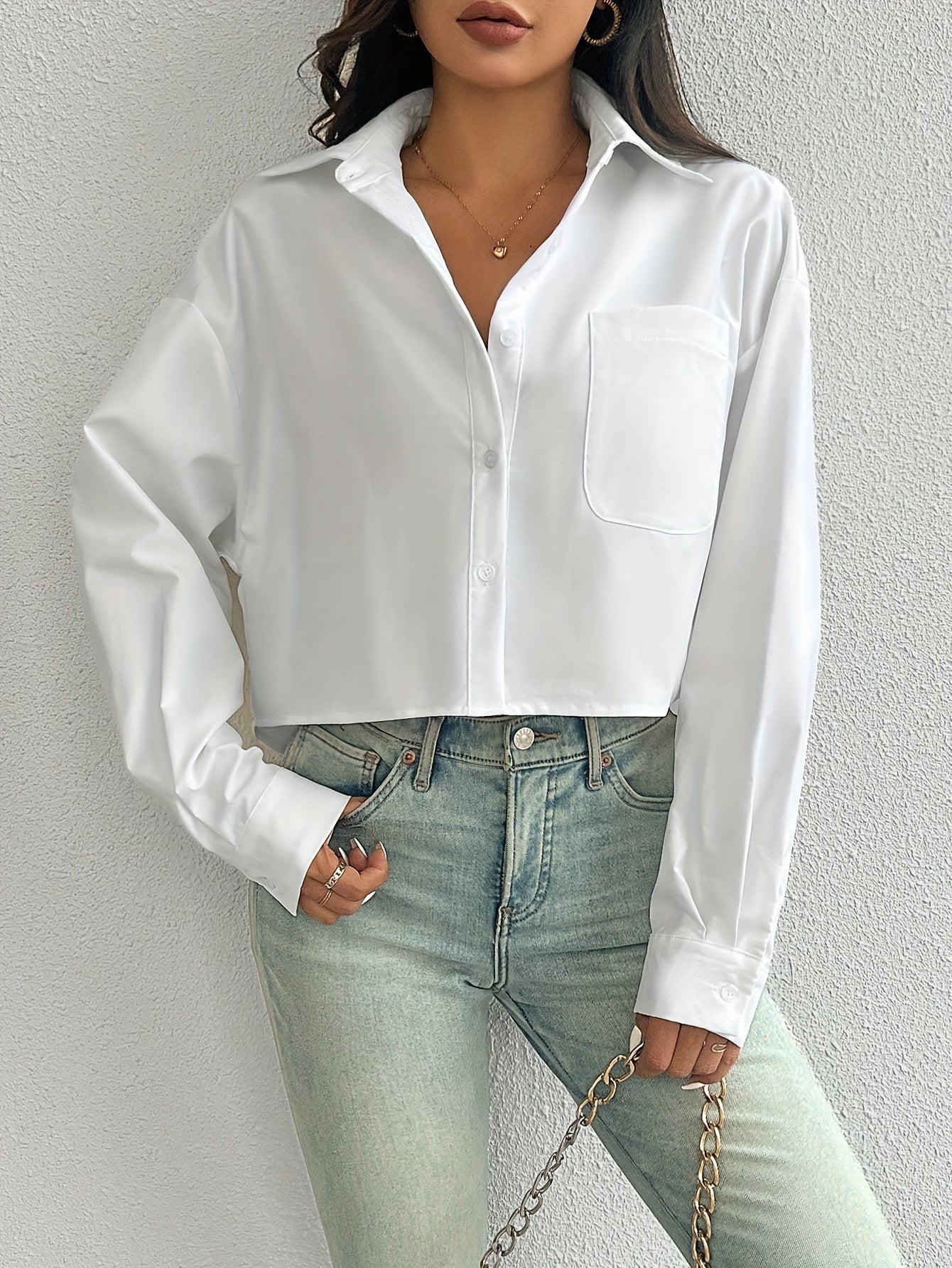 Stylish white casual shirt for women, drop shoulder, long sleeve, short style with pocket, button-up, made of 100% polyester, machine washable, ideal for casual wear.