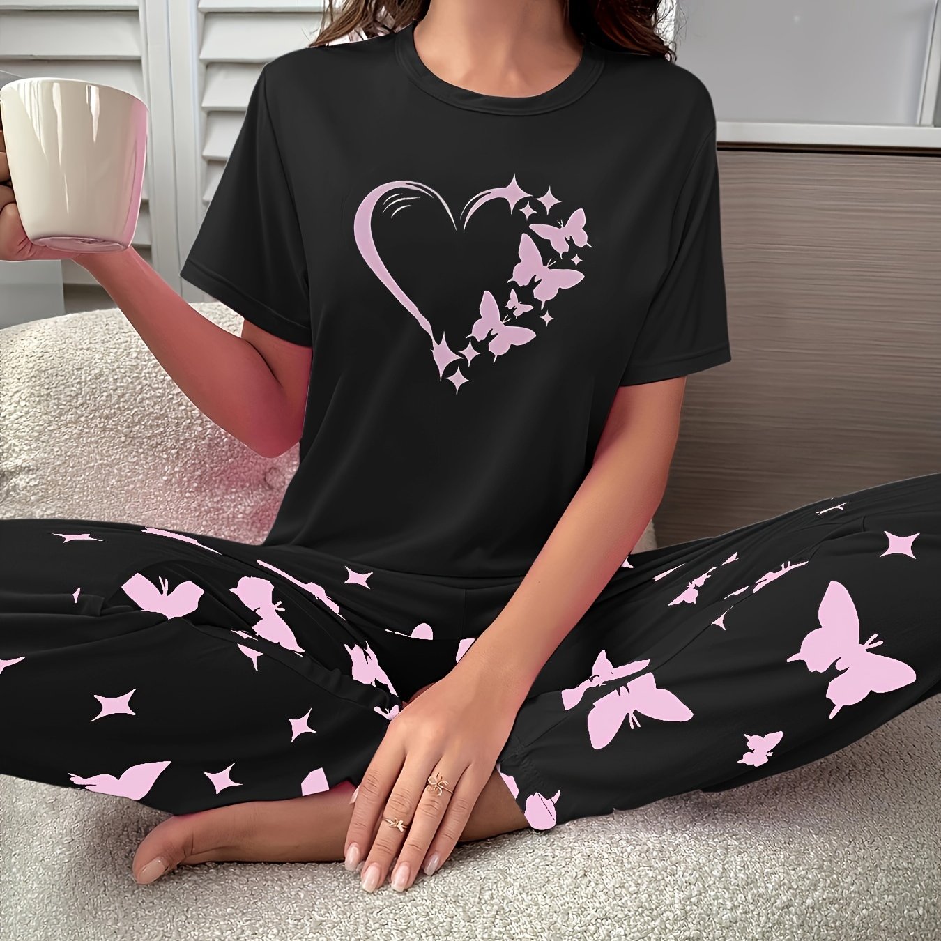 Heart and butterfly print pajama set for women, including a short sleeve top and loose long pants for lounging and sleeping.