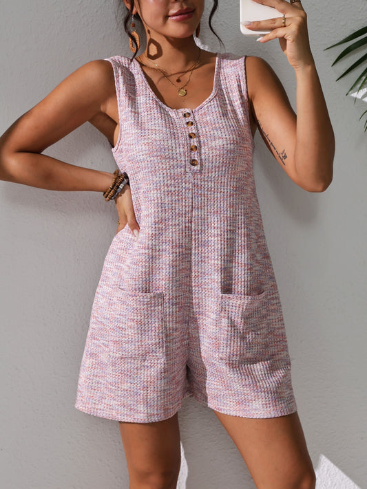 Sleeveless waffle knit romper with pockets for plus-size women in pastel pink. Comfortable and stretchy, perfect for spring/summer.