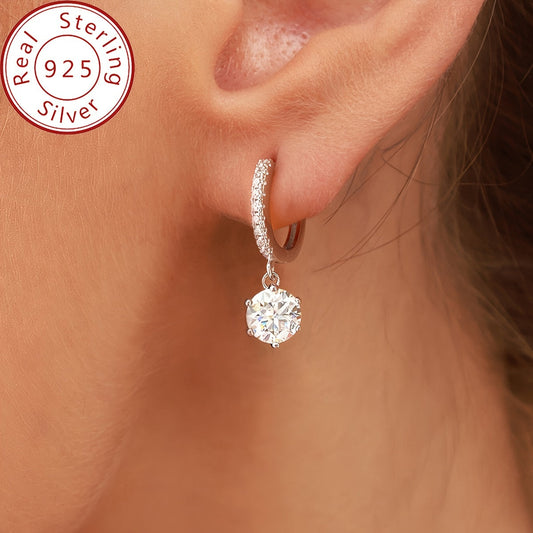 Elegant and luxurious 925 silver earrings designed with six prongs and inlaid with shiny 1ct Moissanite. Perfect for ladies, ideal for special occasions like banquets, anniversaries, or birthdays. A fashionable and delicate accessory weighing 2.6g.