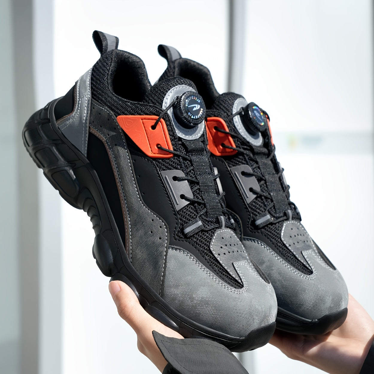 Steel toe work shoes with breathable design, puncture-resistant sole, and durable fabric upper in gray/black/orange. Perfect for construction and industrial tasks.