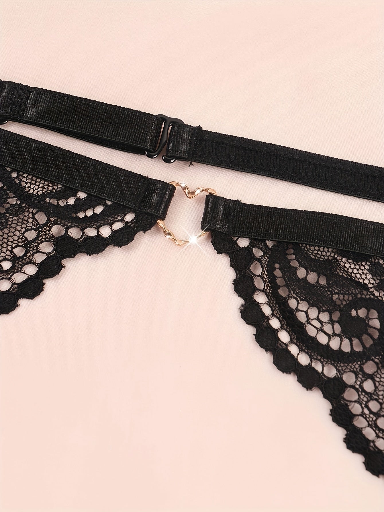 Lace garter belt set for women includes bra, panties, and stockings made from nylon-spandex blend; hand washable.