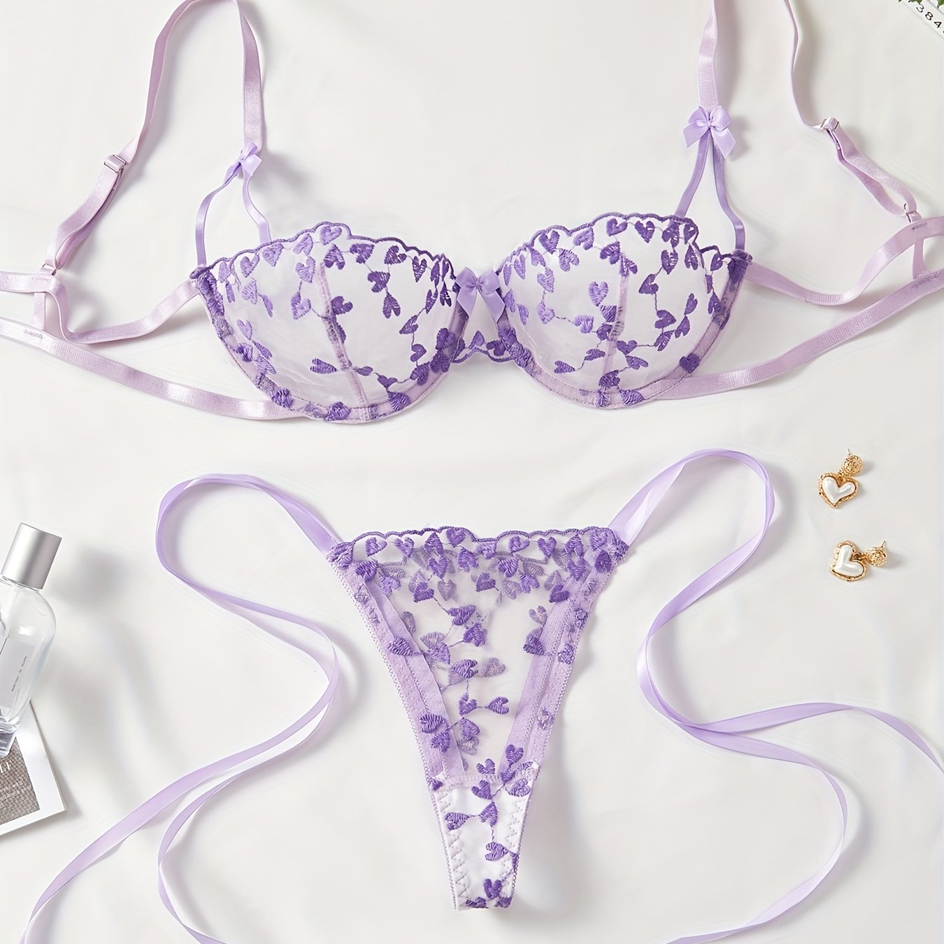 Purple mesh lingerie set with heart embroidery, bow decor, semi-sheer bra and tie side thong. Women's sexy underwear.