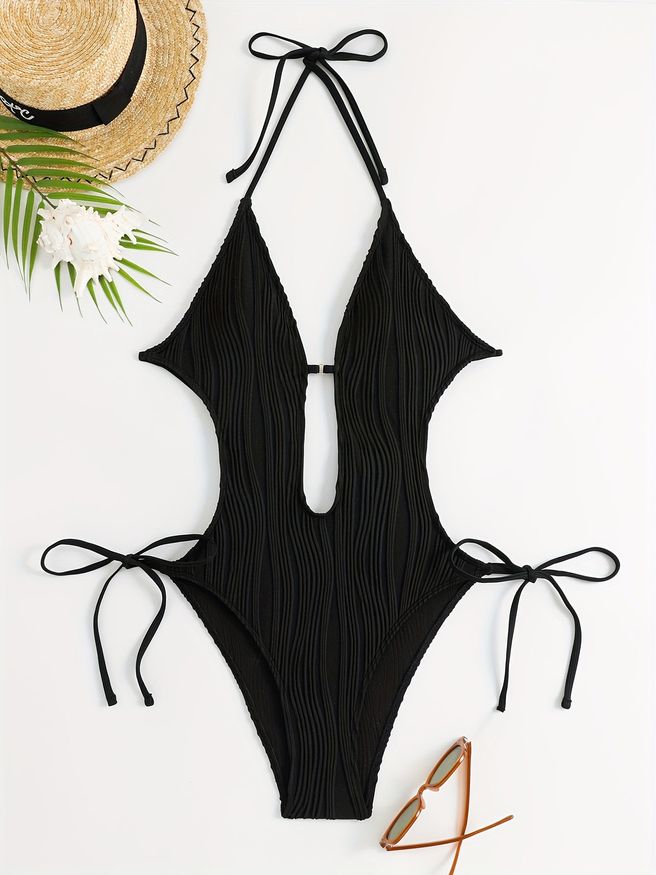 Sexy, high stretch backless halter one-piece swimsuit for women with tie detail; machine washable.