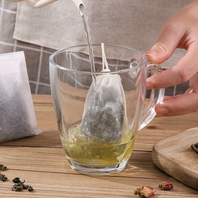 100 pieces of disposable drawstring tea bags made of non-woven material. These food-safe filter bags are perfect for brewing Chinese medicine, seasoning, straining soup, and separating residue.