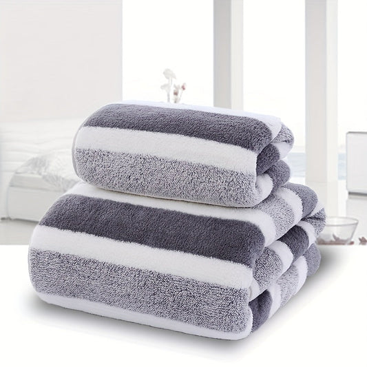 Two pieces of towels with a striped pattern, featuring a soft hand towel and a bath towel. These quick-drying, absorbent towels are perfect for the bathroom and come as part of your bathroom supplies.