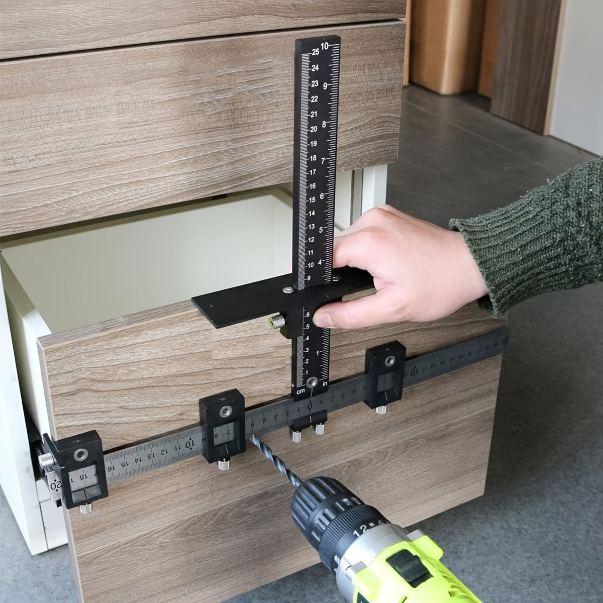 Guide for installation of door and drawer handles and knobs with black cabinet hardware jig tool.