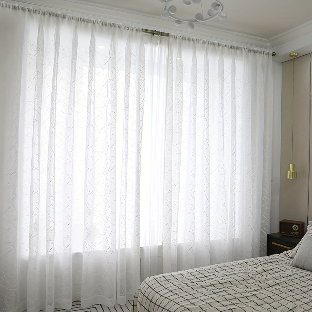 Create a modern and sophisticated look in your living room or bedroom with this 1-piece simple line embroidery sheer curtain. Featuring a sleek geometric design in white, this translucent curtain filters light beautifully while adding a stylish touch to