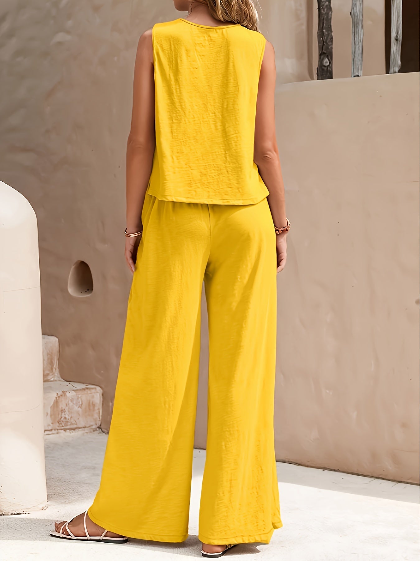 Elegant two-piece set with sleeveless tank top and wide leg loose pants for women.