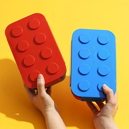 Red and blue building block-inspired lunch box with utensils, featuring a leakproof and microwave-safe design. This 3-compartment, large capacity double-layer bento box is made of durable polypropylene, making it perfect for school, work, camping, and