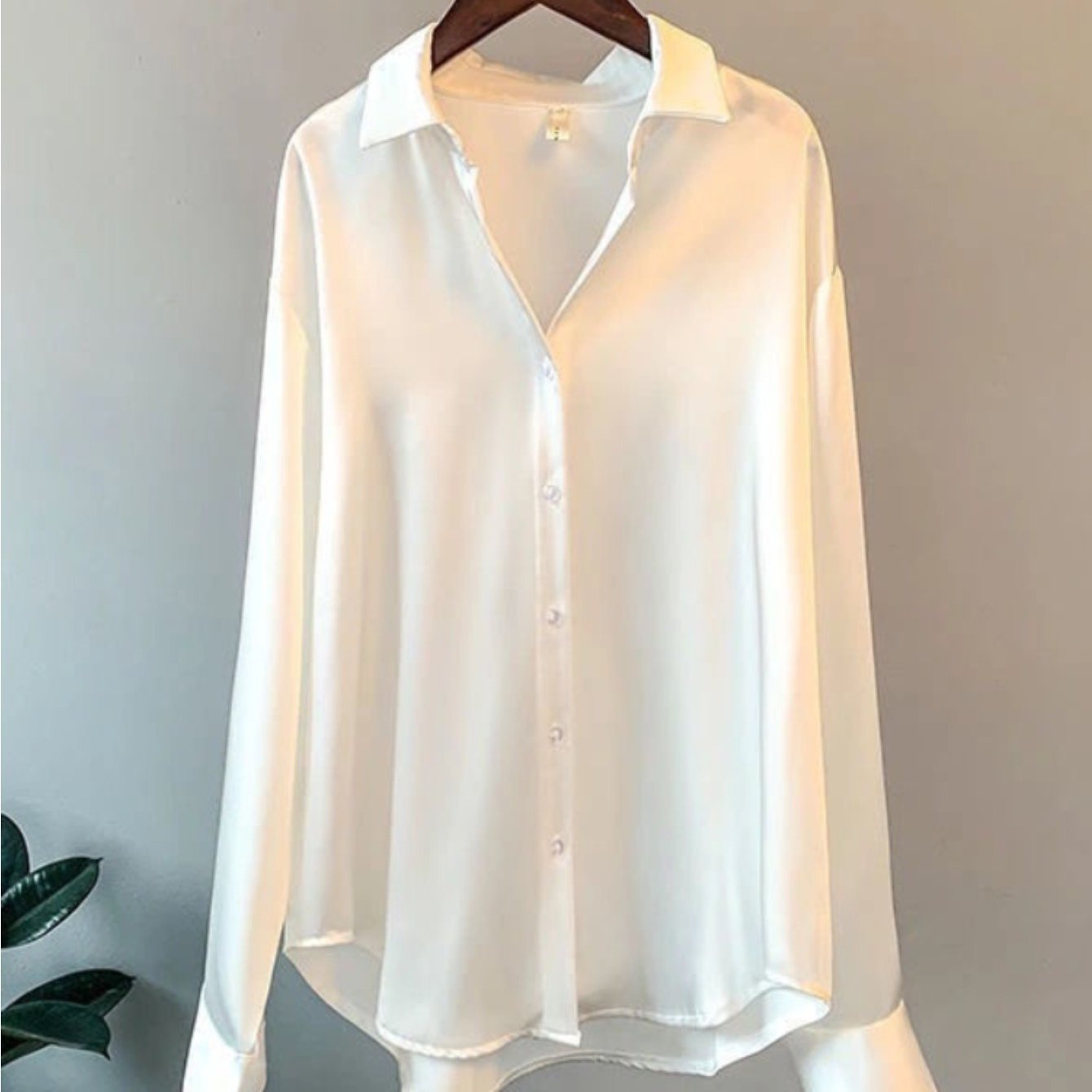 Solid, collared blouse with long sleeves and buttons for women's plus size clothing.