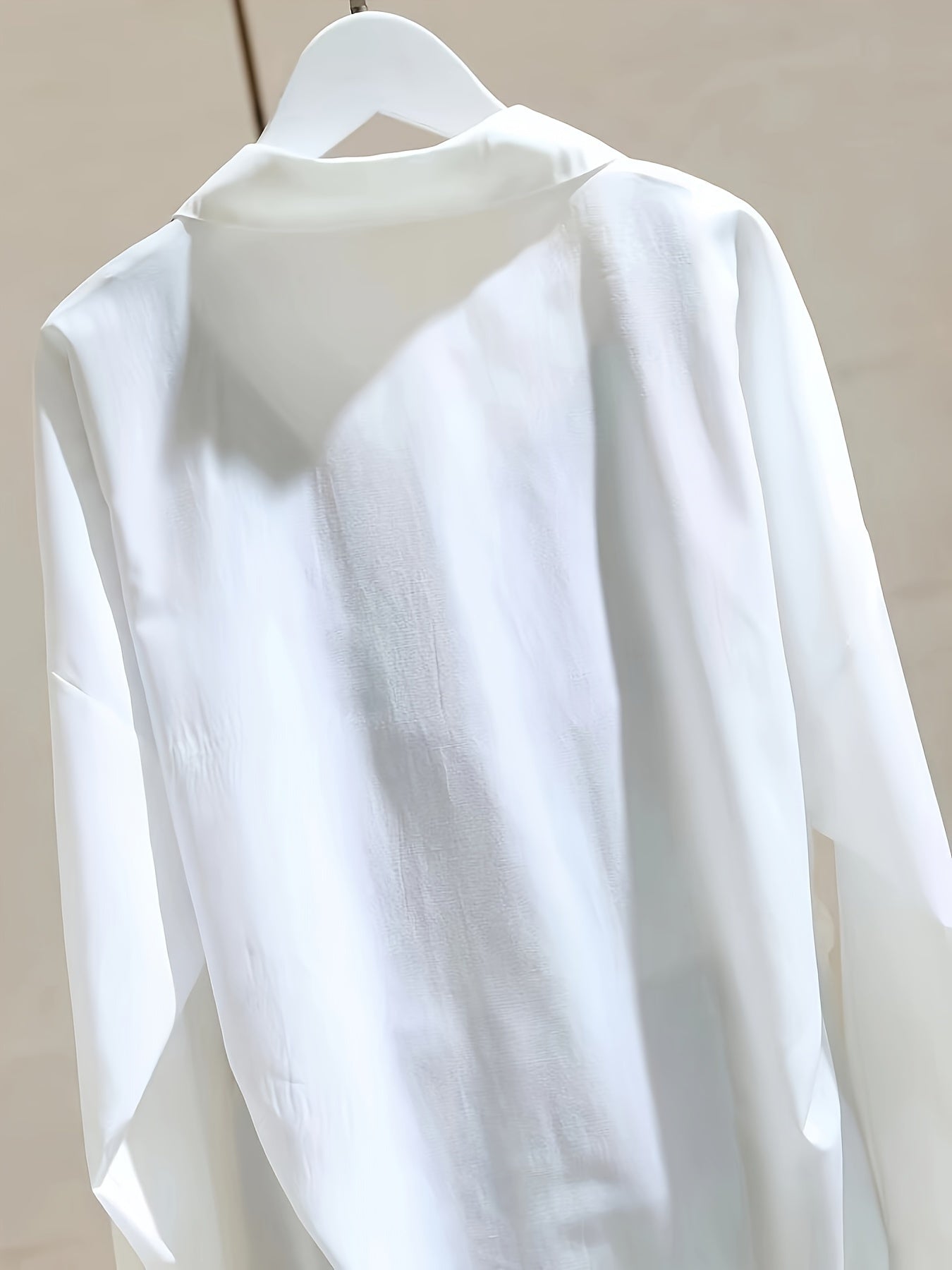 White loose-fitting shirt for women with striped patchwork, perfect for spring and autumn, in a unique casual style.