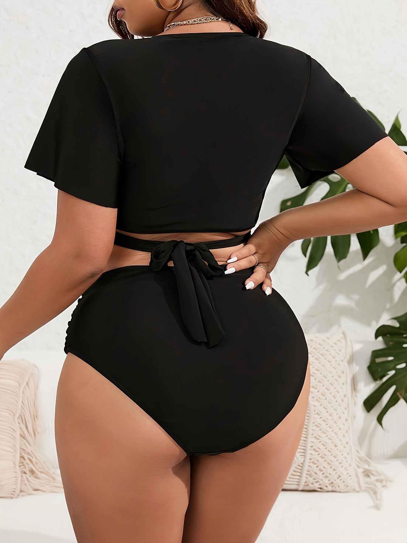 High-waisted solid color bikini with fly sleeves in a larger size.