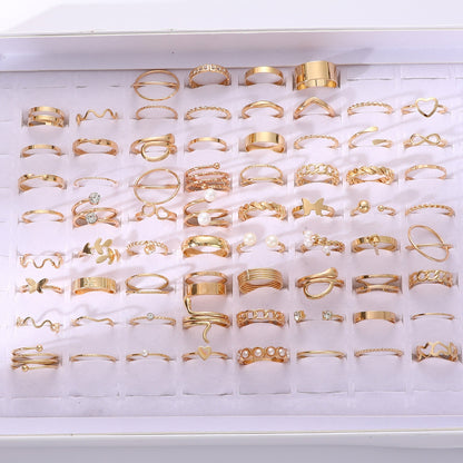 This stylish stackable ring set features 68 pieces adorned with faux pearls and cubic zirconia, showcasing elegant heart and butterfly designs. The rings are in a beautiful golden tone, perfect for everyday wear or special occasions. Perfect for adding a