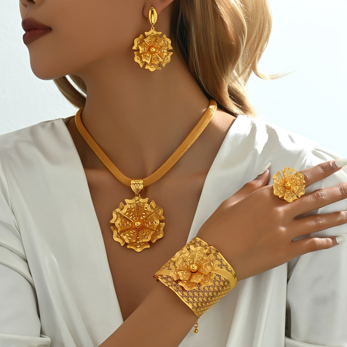 Luxurious five-piece bridal wedding accessories set featuring intricate flowers, stunning bracelets, rings, earrings, pendants, and necklaces in a bold ethnic design. This golden jewelry set is perfect for special occasions like banquets and vacations.