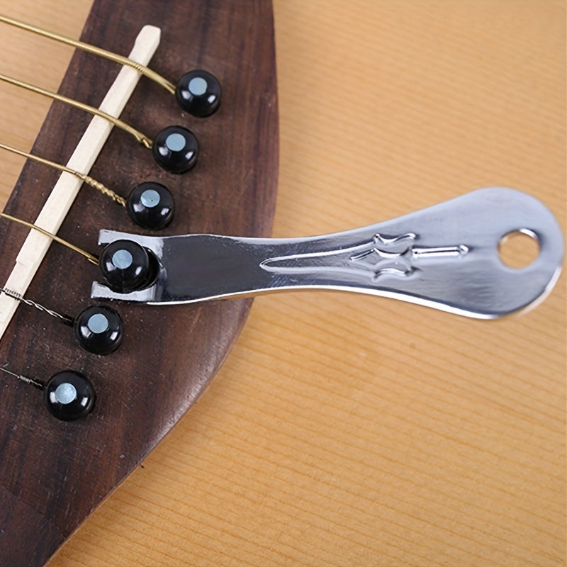 The utility model is a tool for prying, pulling, and removing guitar nails.