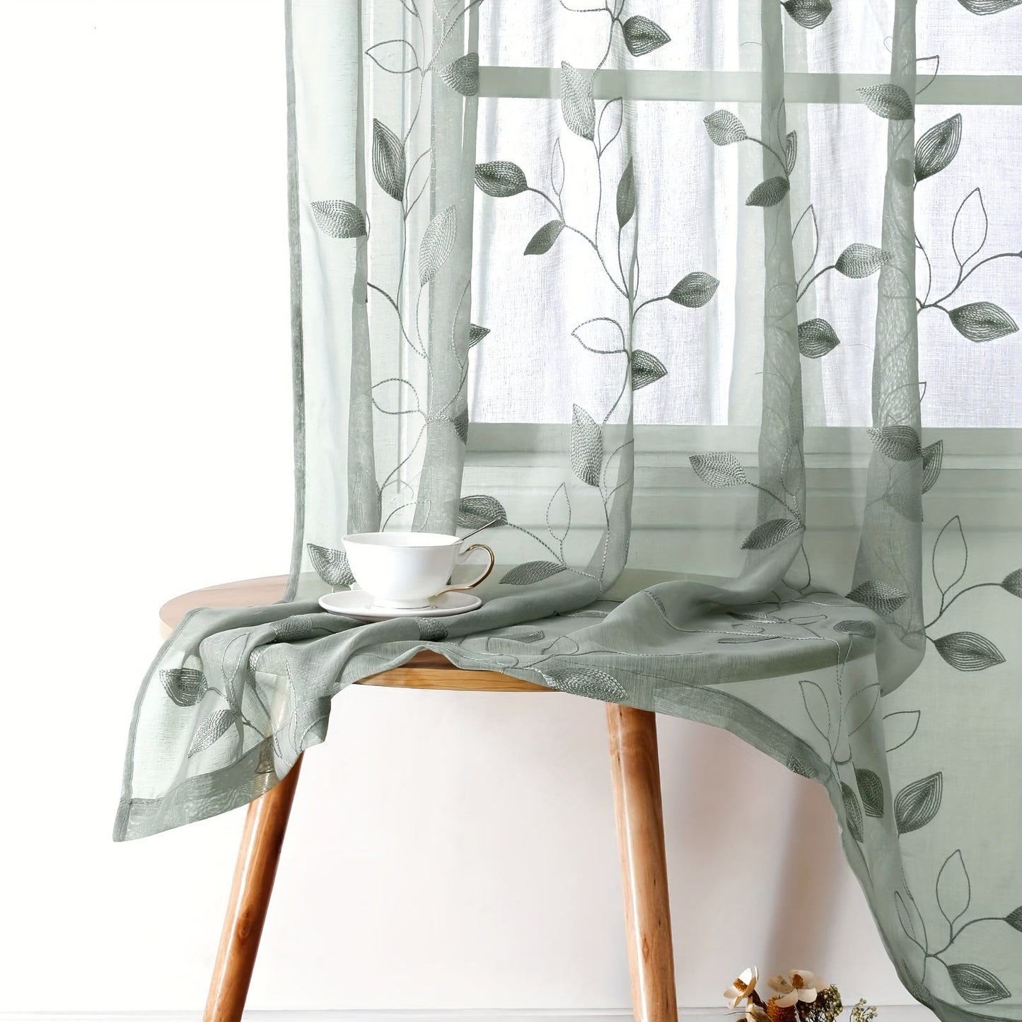 Two pieces of garden-style sheer curtains with an embroidered leaf pattern, featuring a rod pocket design. Made of polyester, these drapes are perfect for bedrooms, living rooms, and kitchens. They are machine washable and suitable for all seasons