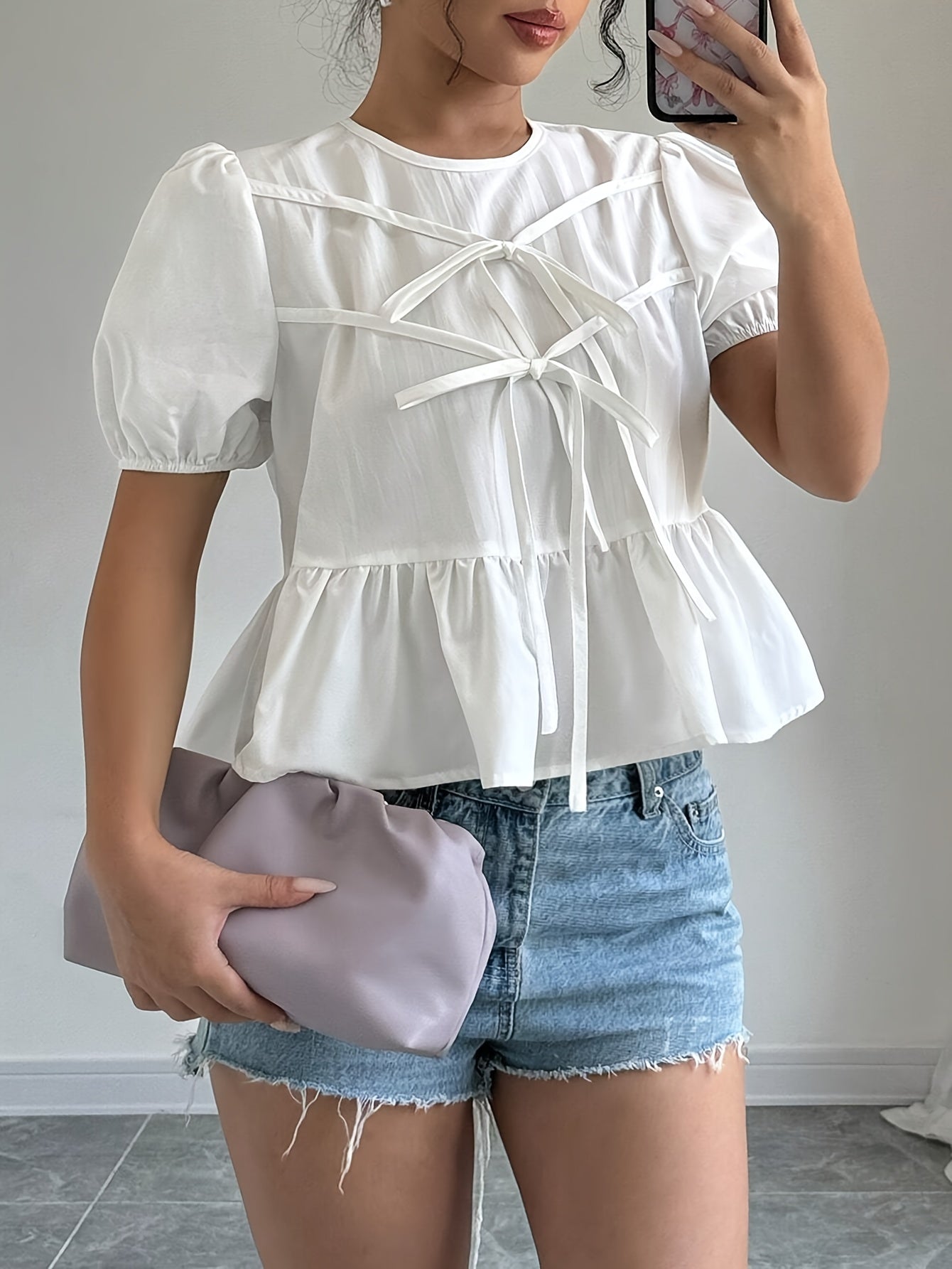 Puff-sleeve shirt with ruffles and front bow tie.