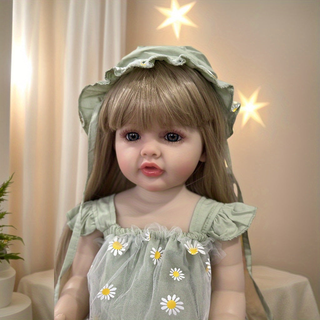 Realistic 55.88 cm full vinyl body reborn baby doll with long blond hair, dressed in a green dress with daisy pattern. Beautiful toddler doll toy for collectors.