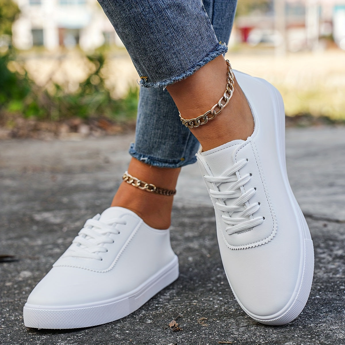 Versatile women's white sneakers with classic design, lace-up closure, round toe, and rubber sole for all seasons. Made with faux leather upper and comfortable fabric lining.