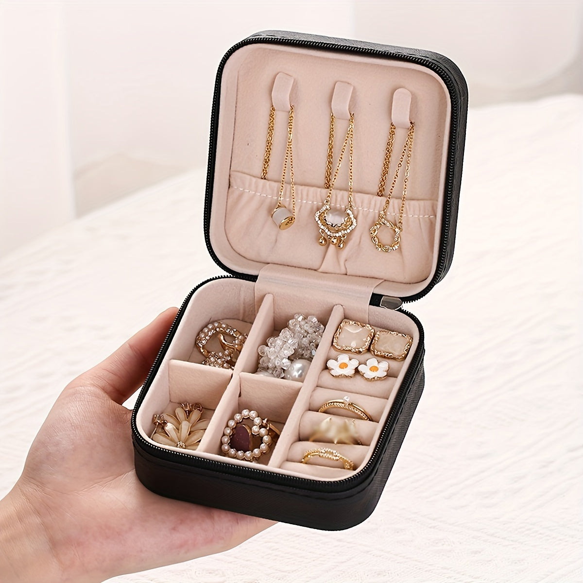 Portable jewelry storage box for traveling, suitable for earrings, necklaces, and rings. Simplistic organizer for jewelry.