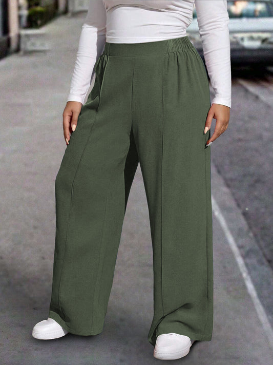 New stylish large women's pants, extended and loose fit, comfortable and light, in a sleek solid color.