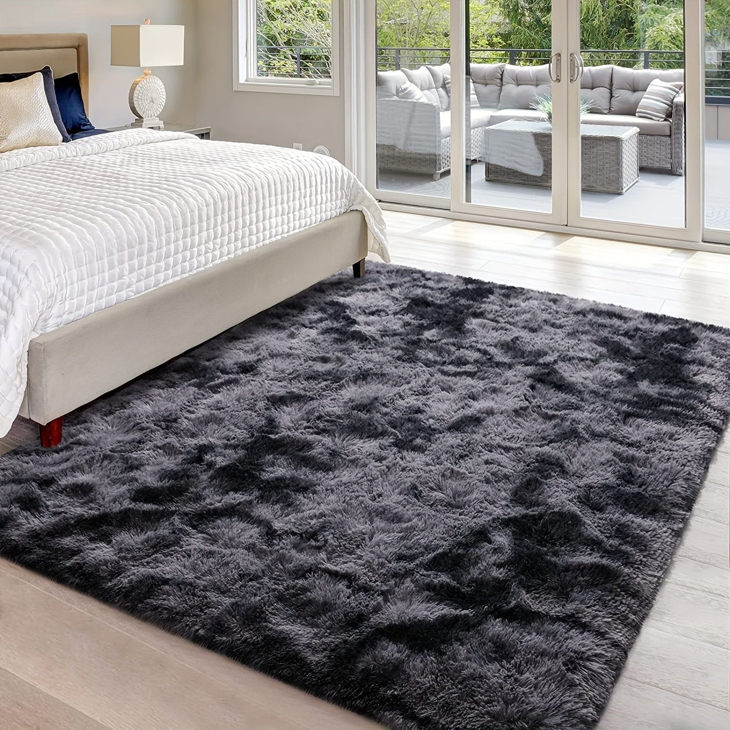 Soft plush area rug in deep grey tie-dye design, perfect for adding a cozy touch to your bedroom or living room. Made of fluffy polyester shaggy material, this carpet is ideal for festive Christmas decor. Rectangular in shape, this rug should be dry