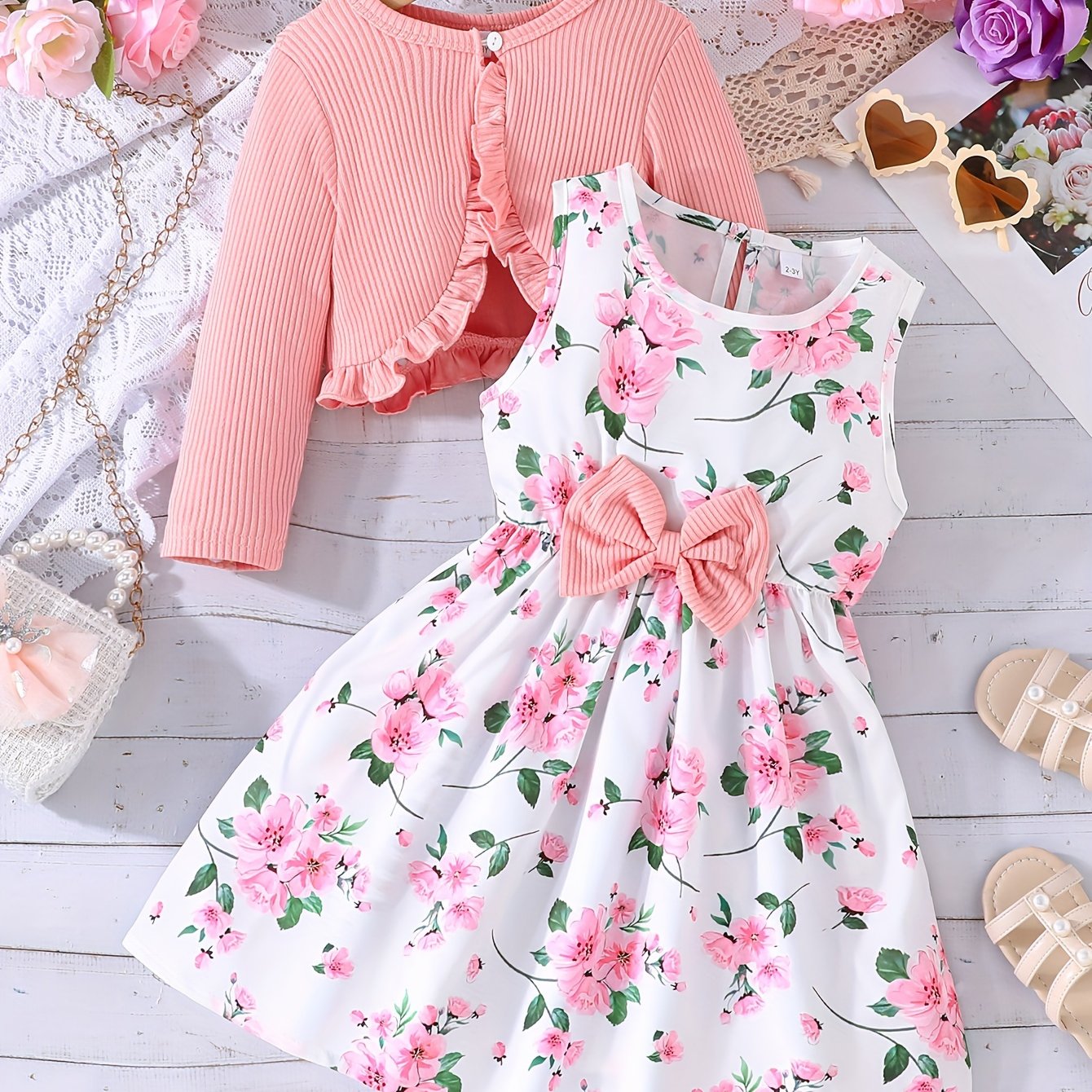 Flower print vest dress with chest measurement paired with a solid color long sleeve jacket for girls.