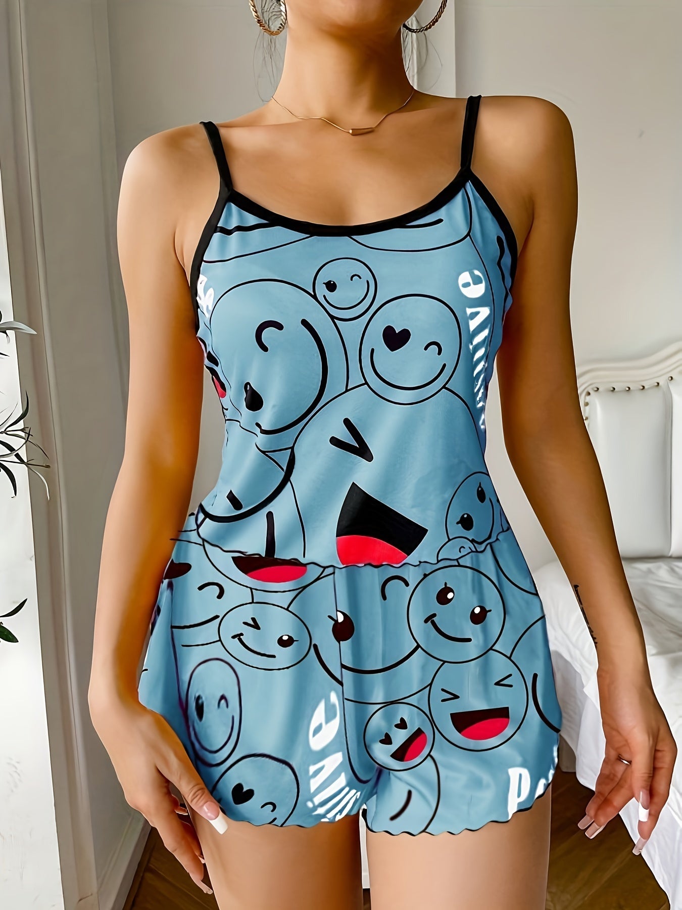 Women's sleepwear set with smiling face print cami top and elastic shorts.