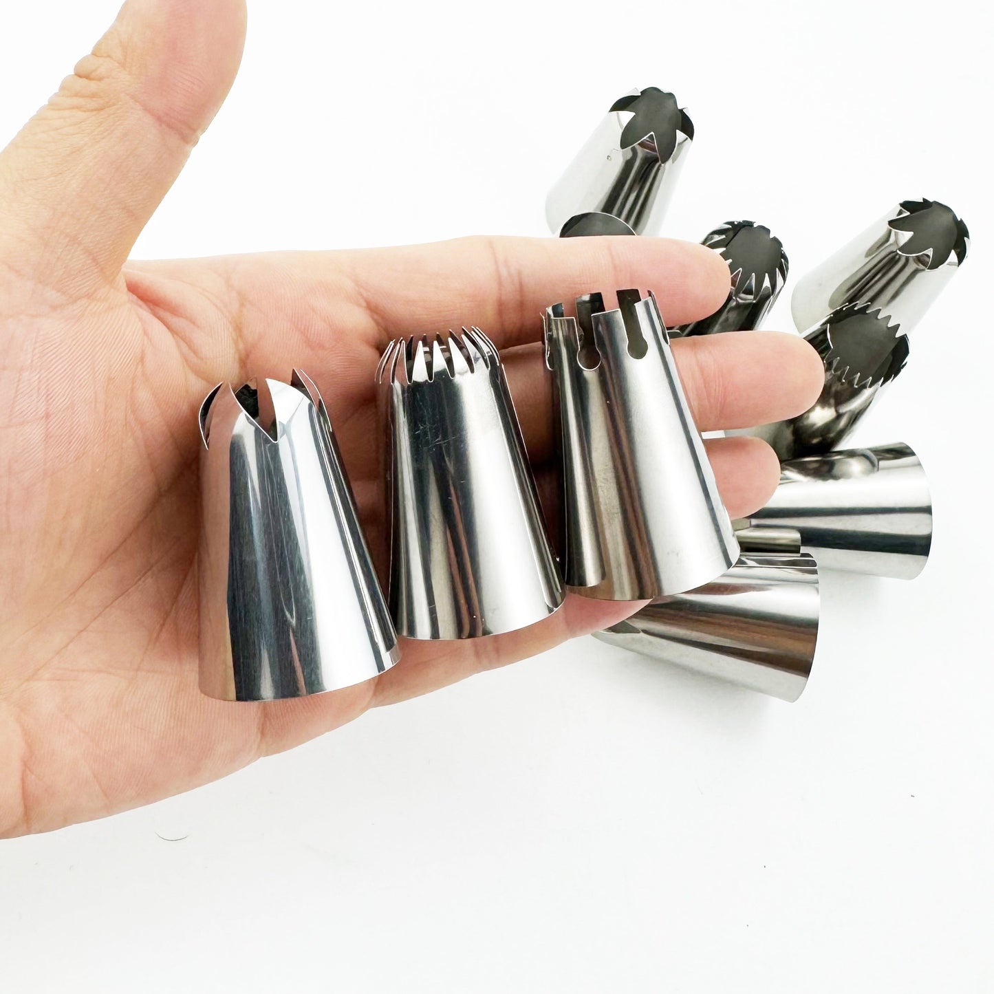 Set of 9 large stainless steel piping tips, perfect for decorating macarons, cakes, and cookies. These versatile nozzles are ideal for holiday baking, including Halloween, Christmas, Easter, Hanukkah, and Thanksgiving. Use these metal cupcake icing tools