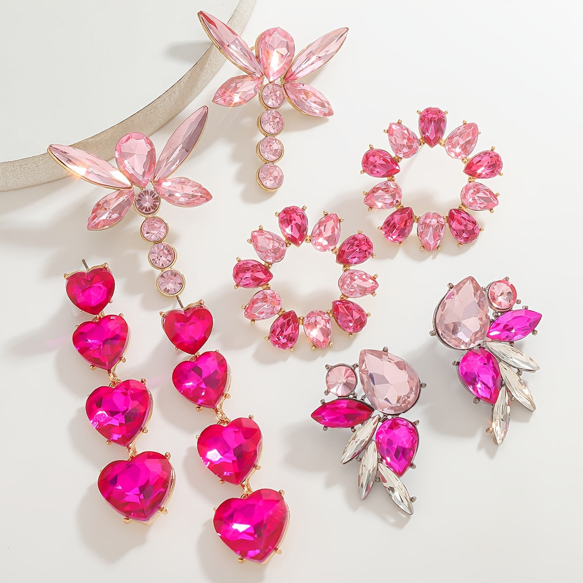 Add a touch of sparkle this Valentine's Day with our Pink Heart & Crystal Winged Drop Earrings. Featuring an elegant bling style, these earrings are made of Zinc Alloy with Stainless Steel Posts, perfect for weddings, parties, and gifts. The Round