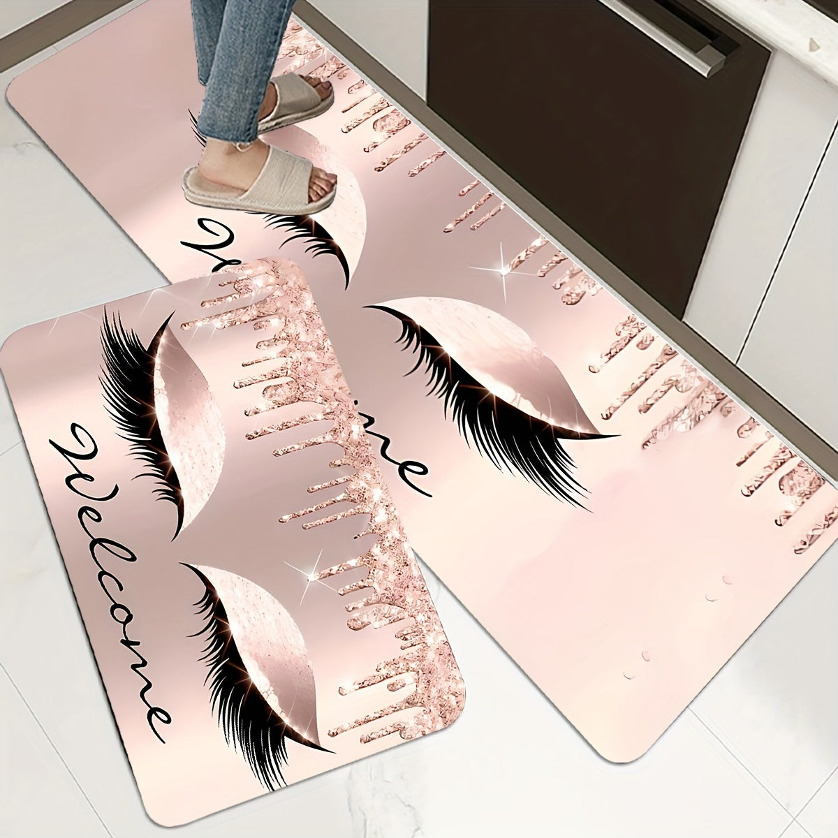 Pink eyelashes and letters patterned kitchen rug made of polyester vinyl material. This mat is anti-slip and absorbent, perfect for use in the kitchen, home office, sink area, or laundry room. It also provides anti-fatigue properties for added comfort.