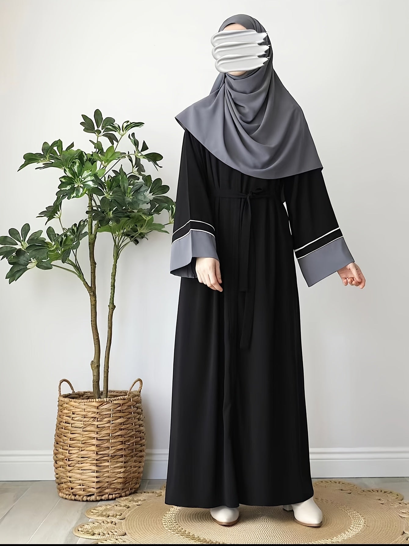 Elegant Black Abaya robe for Middle Eastern Muslim women with long sleeves and loose fit.