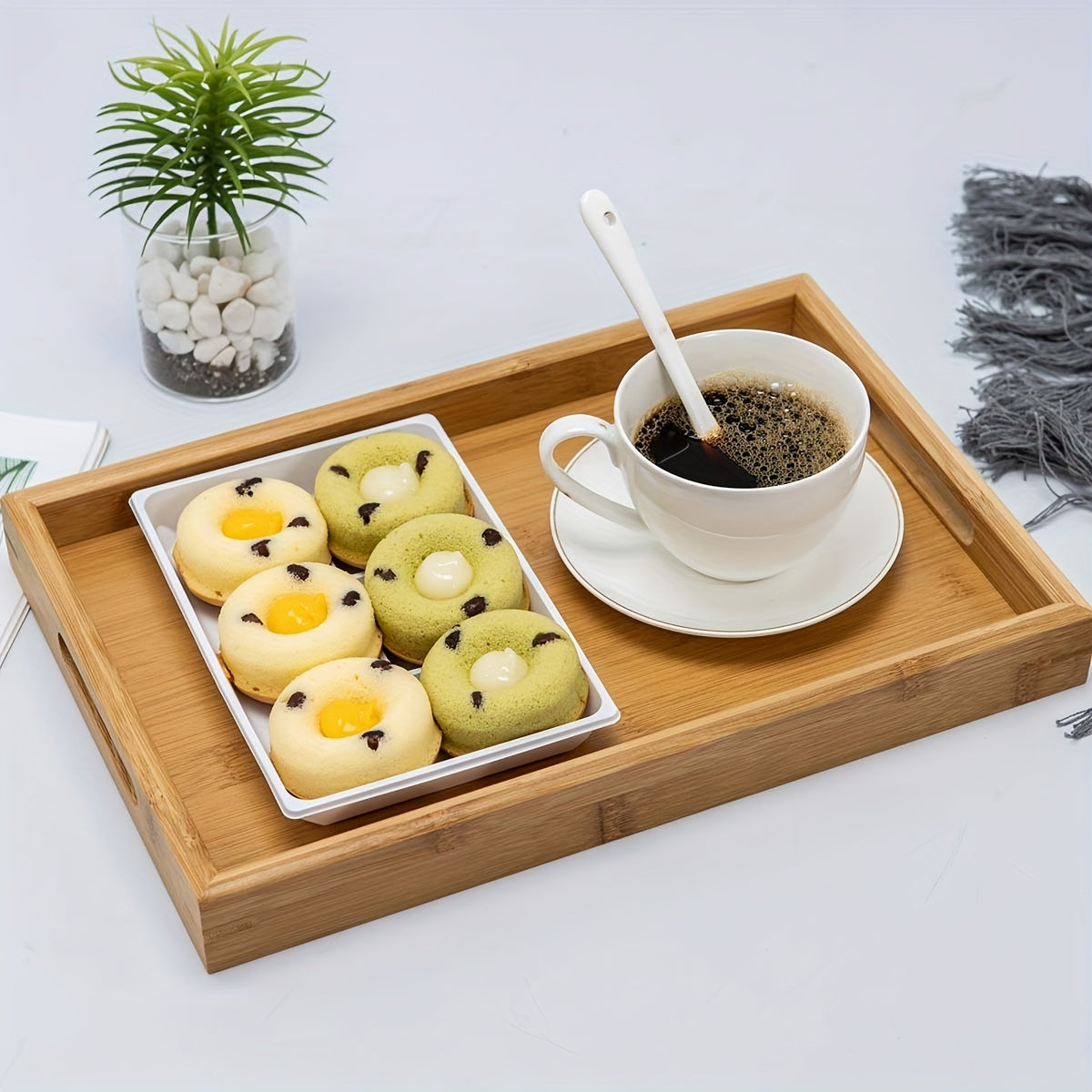 Bamboo serving tray with handles for eating, working, and storing in various locations.