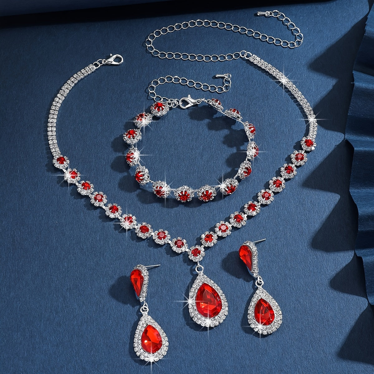 A set of three jewelry pieces for brides and ladies, including one necklace, one pair of earrings, and one bracelet, all featuring flower drop designs. Perfect accessories to complement any dress.