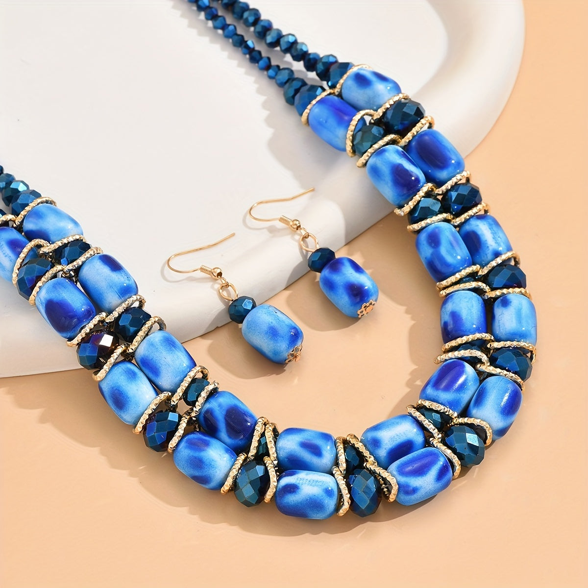 Complete your look with this Bohemian-style women's jewelry set featuring a 2-strand beaded necklace and earrings, suitable for everyday wear or special events.