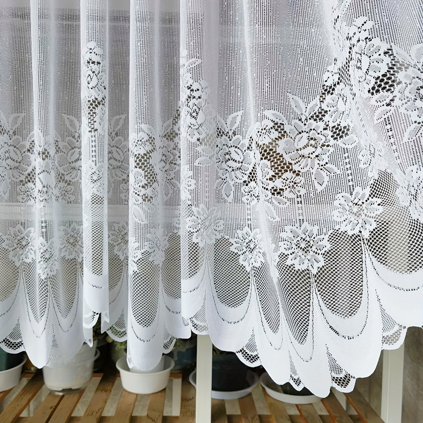 Bring elegance to your windows with our 1-piece White Lace Sheer Curtain featuring delicate floral patterns. This curtain has a rod pocket, scalloped bottom, and is made of lightweight polyester voile, perfect for dining rooms and kitchens. It is