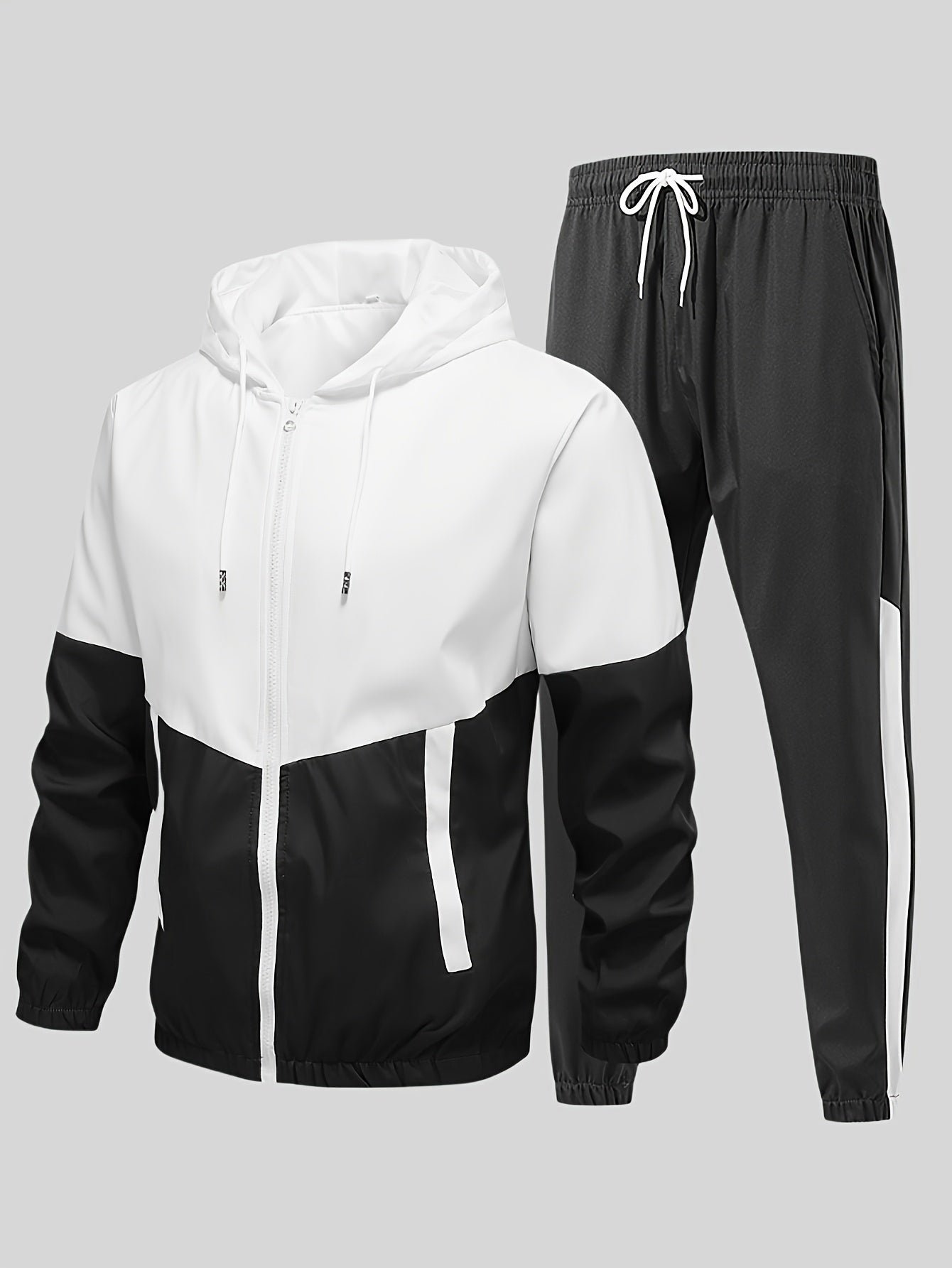 Casual men's sports suit with hooded jacket and pants, featuring a trendy color block design. Made of polyester with slight stretch, drawstring detail, and regular fit.