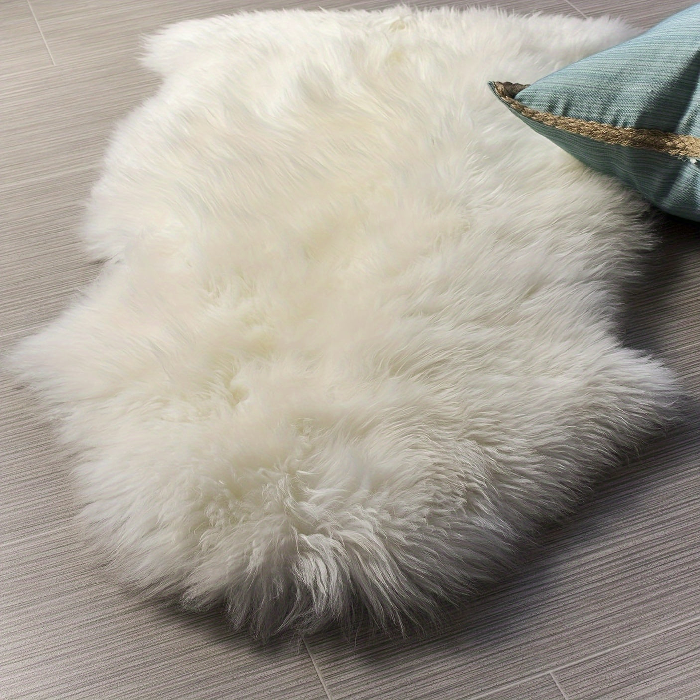 Soft and plush white faux sheepskin rug runner, perfect for nursery or living room decor. Machine washable with a flat weave, ideal for children's rooms. Measures a maximum size of 2.16m² and maximum length of 1.8m.