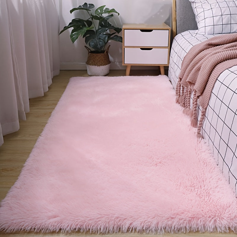 Soft and fluffy pink area rug, machine washable with a shaggy design. Perfect for adding a cozy touch to any living room, nursery, or dorm room. Non-slip and aesthetically pleasing.