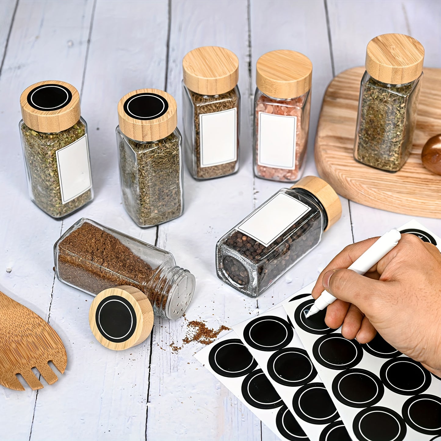 12-piece glass spice jar set with bamboo lids, labels, and funnel for airtight kitchen storage of seasonings and condiments.