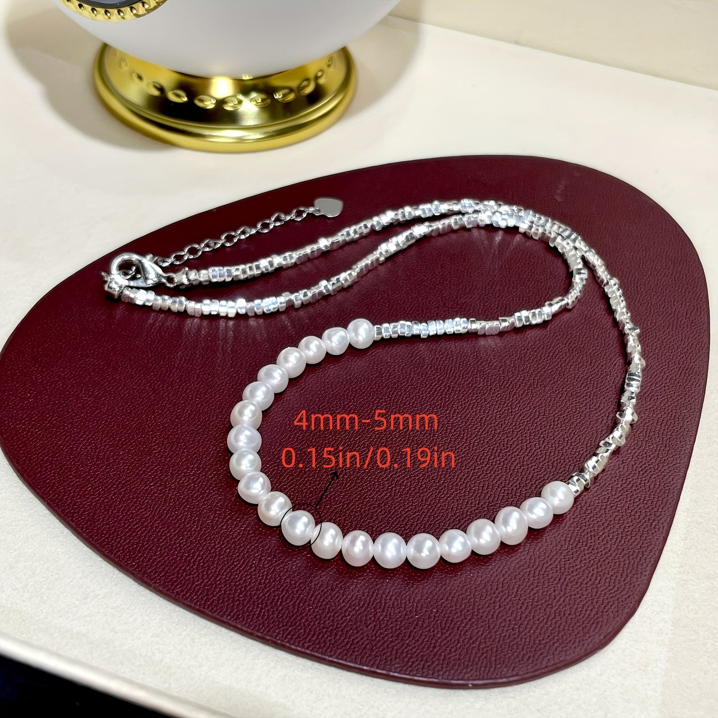 This elegant and versatile necklace features a natural freshwater pearl set in 925 sterling silver. Perfect for women who appreciate timeless glamour and chic style, this piece is ideal for gifting to loved ones or treating yourself. With its 18K gold