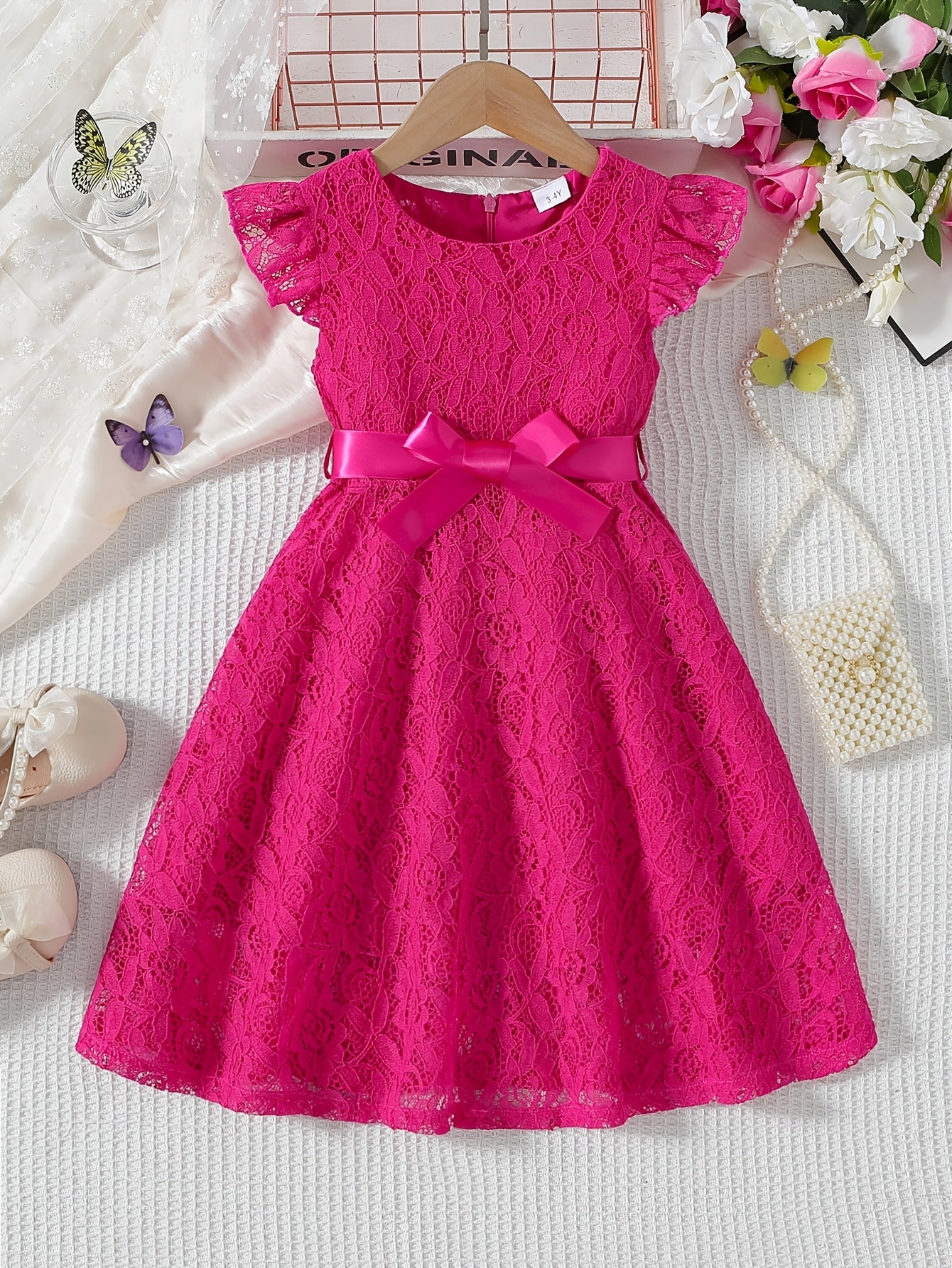 Girls' spring/summer dress with lace detail, belt, and flutter sleeves, ideal for daily wear or birthday parties.