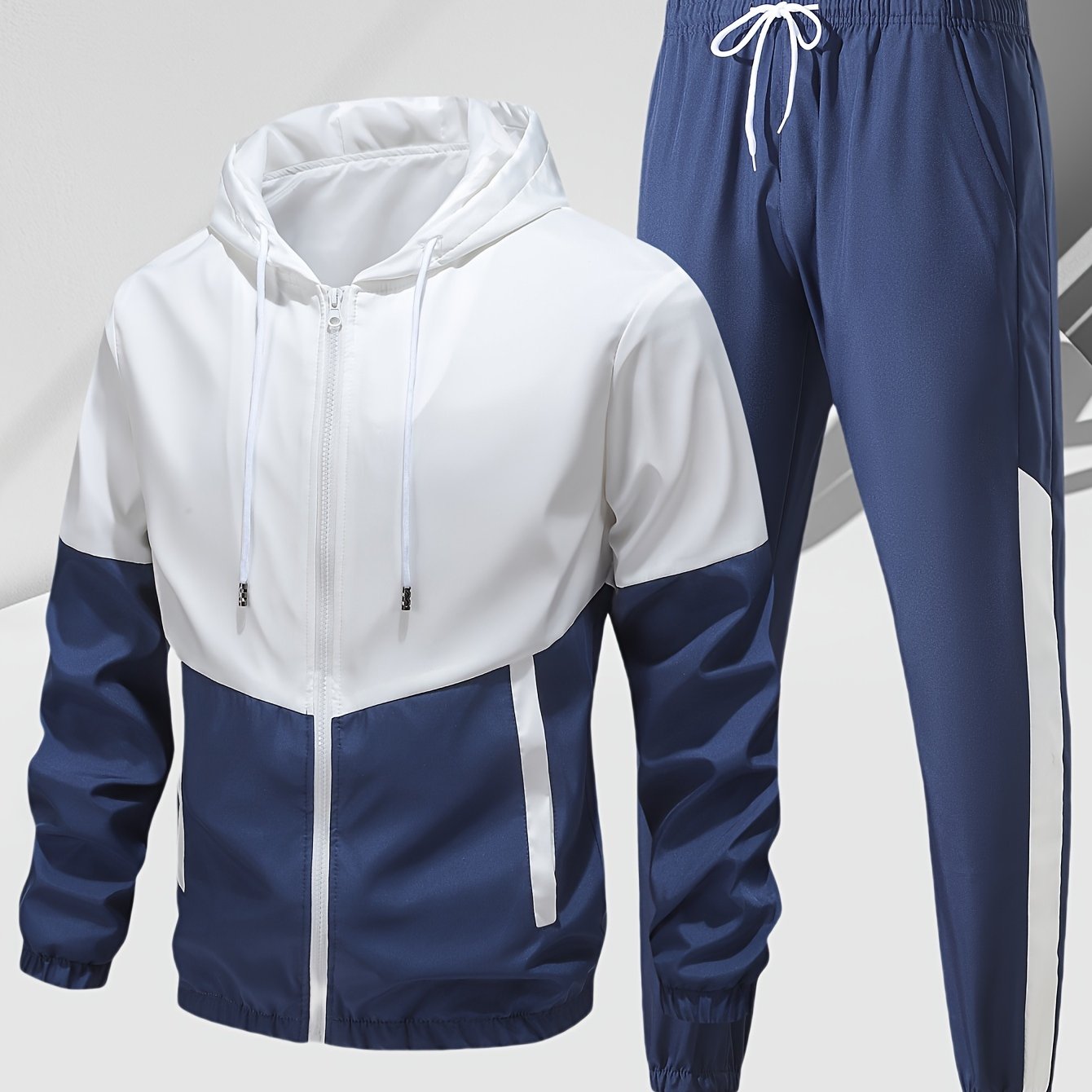 Men's 2-piece casual sports set with hooded jacket and pants in a stylish color block design for a trendy athletic look during spring or autumn.