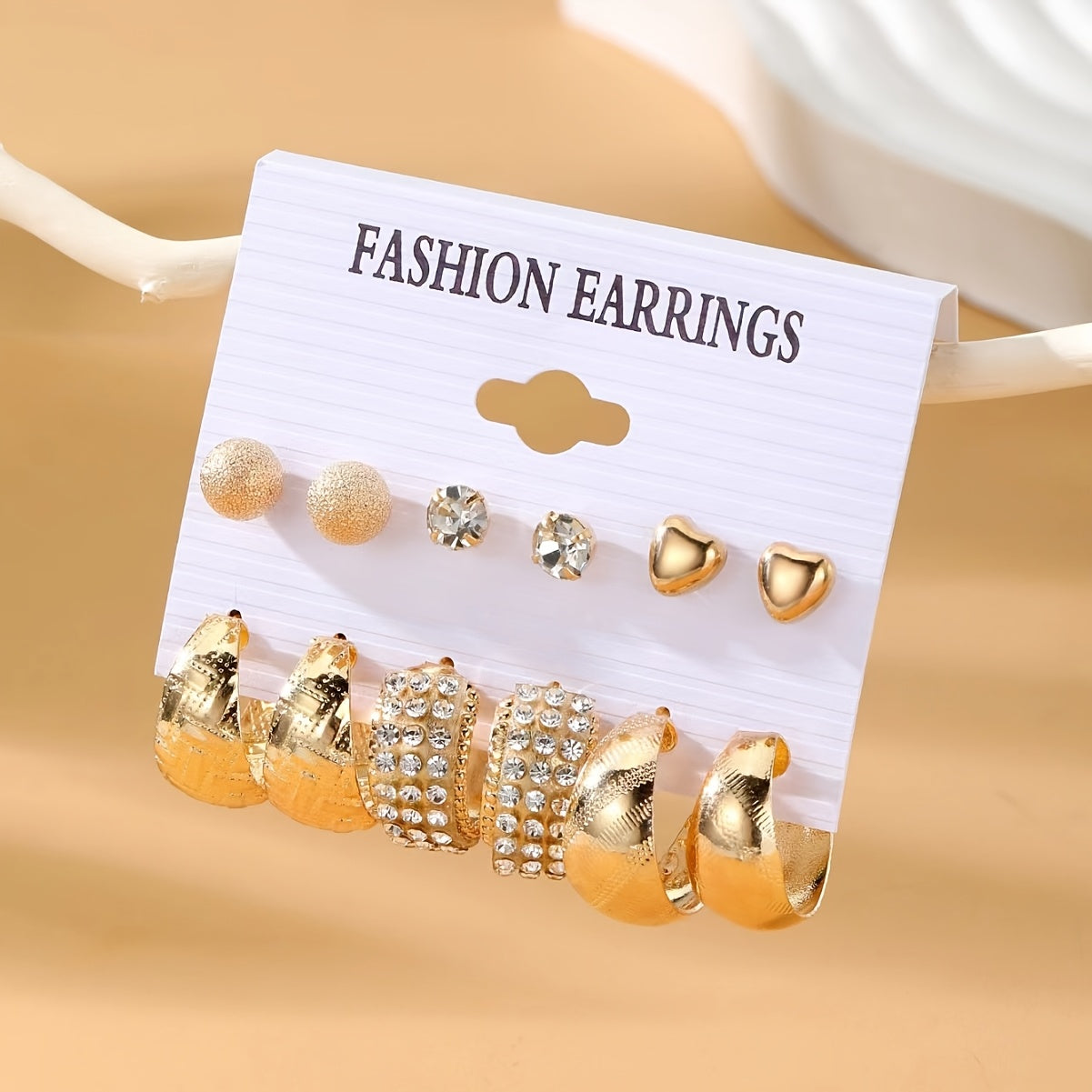 Punk style 6-pair set of metal earrings with textured and heart studs. Made of zinc alloy with rhinestones and stainless steel posts. Versatile for daily and party wear. Perfect gift