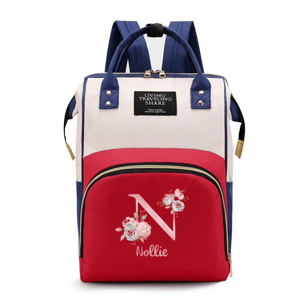 Personalized Mommy Backpack made of durable Oxford cloth with ample storage space for diapers and other essentials. Features customizable initials and name, as well as convenient bottle pockets. Perfect for nursing mothers on-the-go, with options for A-Z