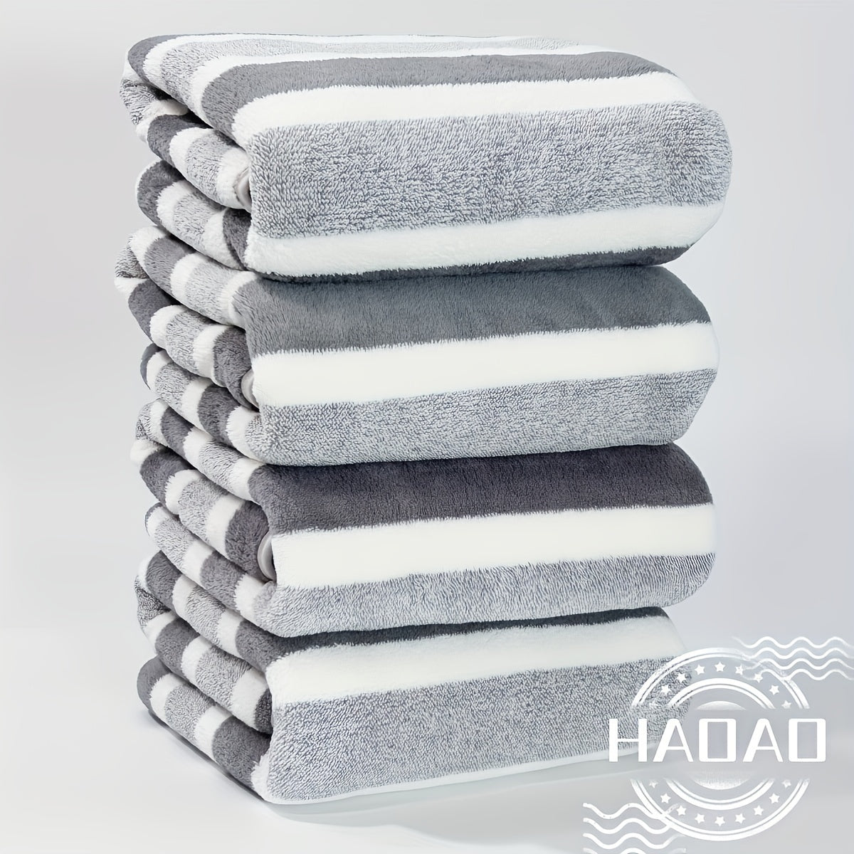 Modern 4-piece coral fleece towel set with geometric pattern, made of 100% polyester for softness and quick-drying absorbency. Ideal space-themed bathroom essential.